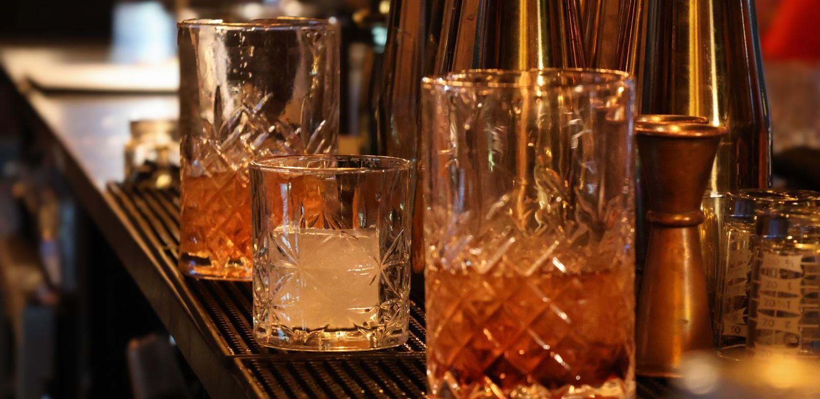 Cut-crystal glasses and a copper jigger on Olé's bar