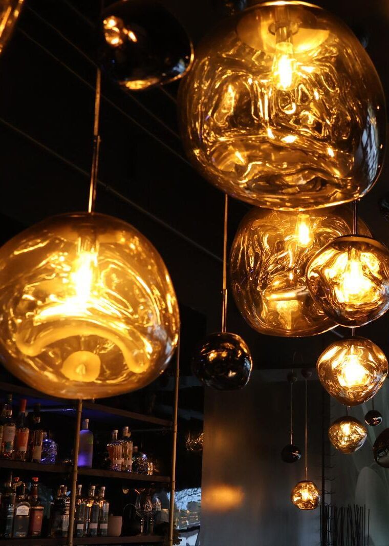Olé's molten amber glass pendants glowing over the bar